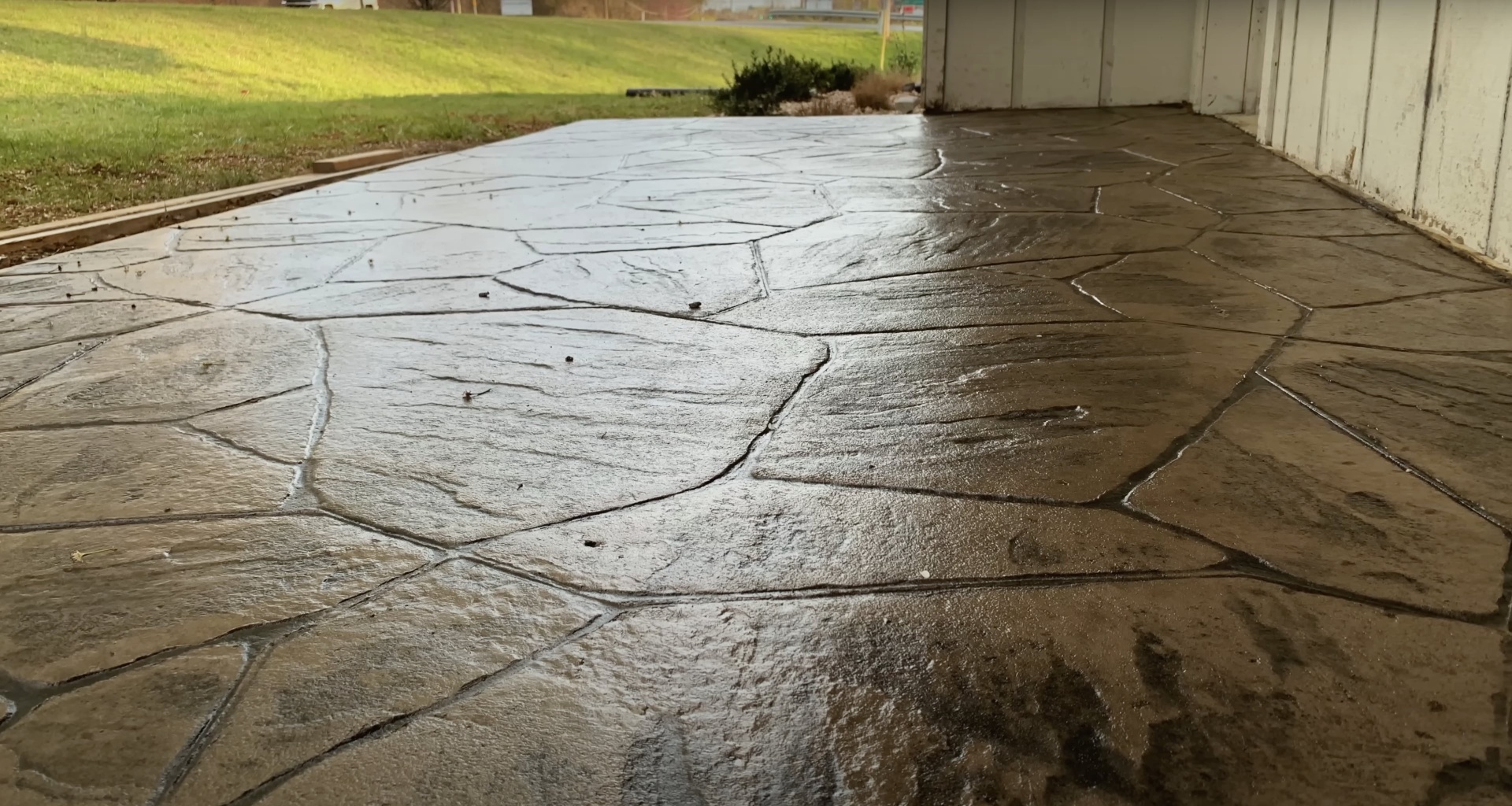 Damaged concrete driveway in need of professional repair or replacement Cracked concrete driveway surface showing wear patterns and damage